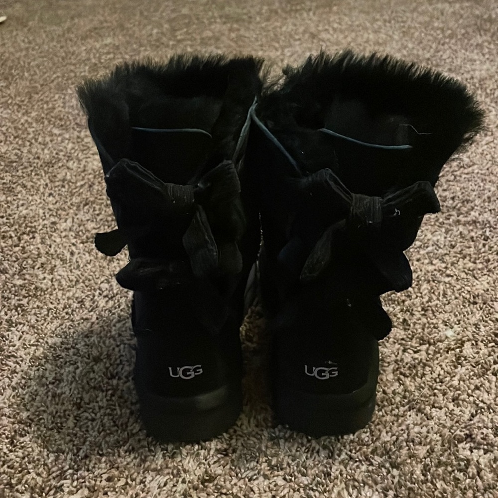 I am selling black boots UGGs with bows on the back.